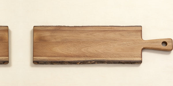 Top-down view of acacia natural edge serving board, blank surface ready for laser engraving