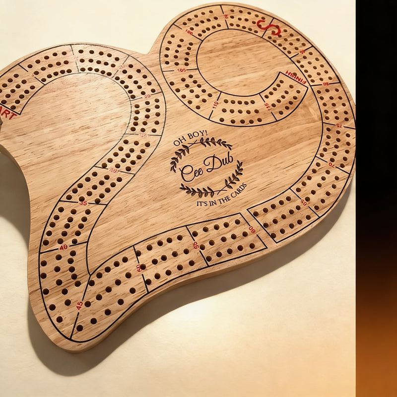 Solid wood 29-shape cribbage board with metal counting pins and engraved logo, top-down view