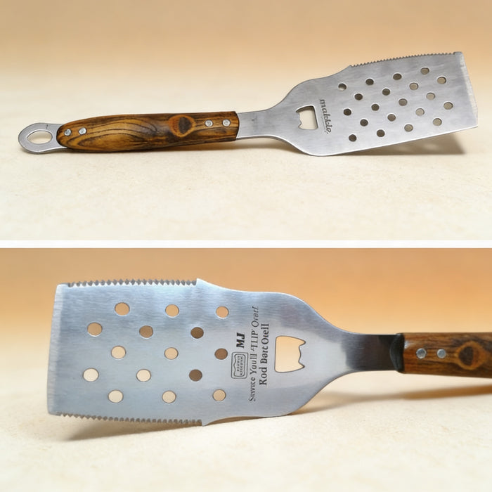 Laser engraved BBQ spatula laid on a wooden surface, showing monogram detail on handle
