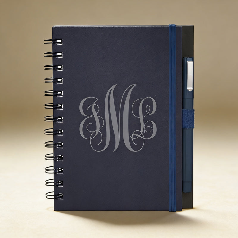 Custom engraved journal open to lined pages, showing pen loop and contacts sheet