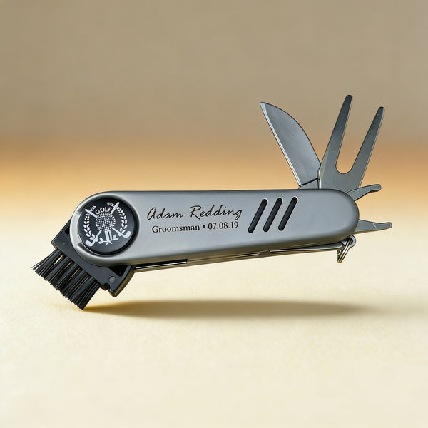 Personalized golf multi-tool engraved with a name, compact metal body with five course tools