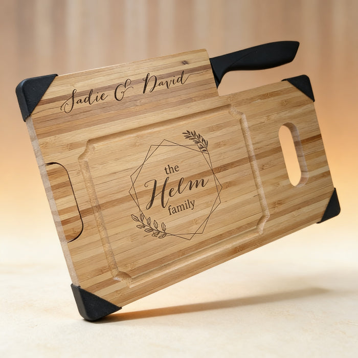 Personalized bamboo cutting board engraved with a family name, standing upright as a knife block