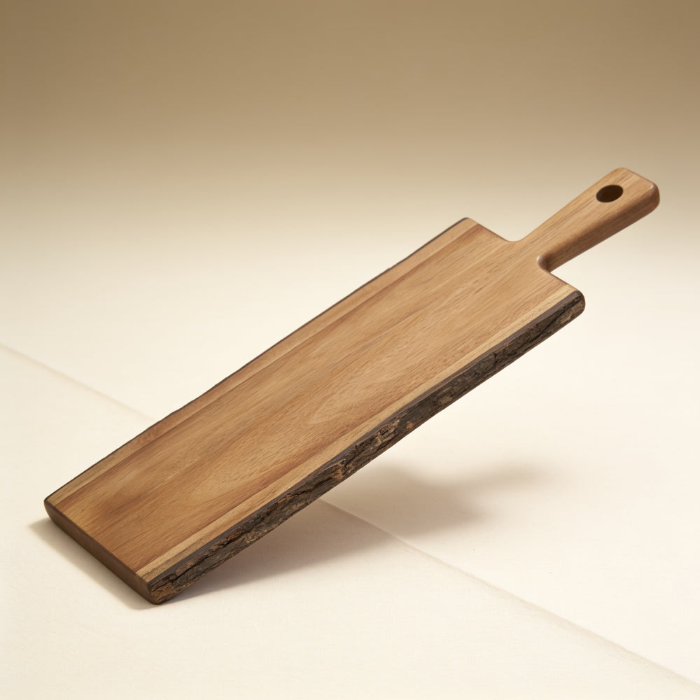 Personalized acacia wood serving board with natural bark edge and handle, 19.5 x 6 in