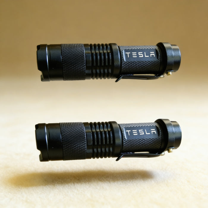 Pink personalized flashlight laser engraved with a monogram, shown alongside 1 AA battery