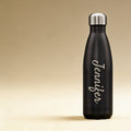 Laser engraved Pin Water Bottle with monogram, shown alongside active outdoor gear