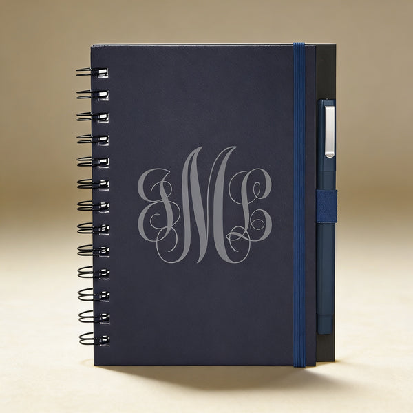 Custom engraved journal open to lined pages, showing pen loop and contacts sheet