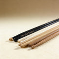 Black hickory drumsticks laser engraved with short phrase, midnight black finish