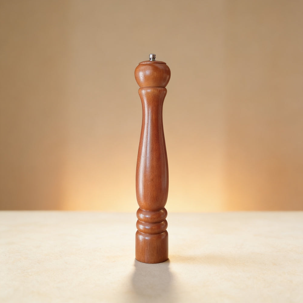 Custom engraved wood pepper mill showing laser-etched monogram on base, natural wood finish