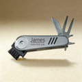 Custom engraved golf multi-tool showing knife, brush, and divot repair tool, top-down view