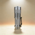 Custom engraved silver focus flashlight showing adjustable magnifying lens and window breaker bezel