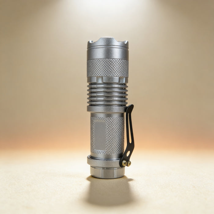Custom engraved silver focus flashlight showing adjustable magnifying lens and window breaker bezel