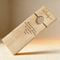 Laser engraved bamboo wine balancer with monogram, shown as a wedding table display piece
