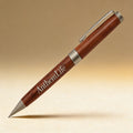 Custom engraved rosewood pen set in presentation case, close-up of laser-engraved monogram on barrel